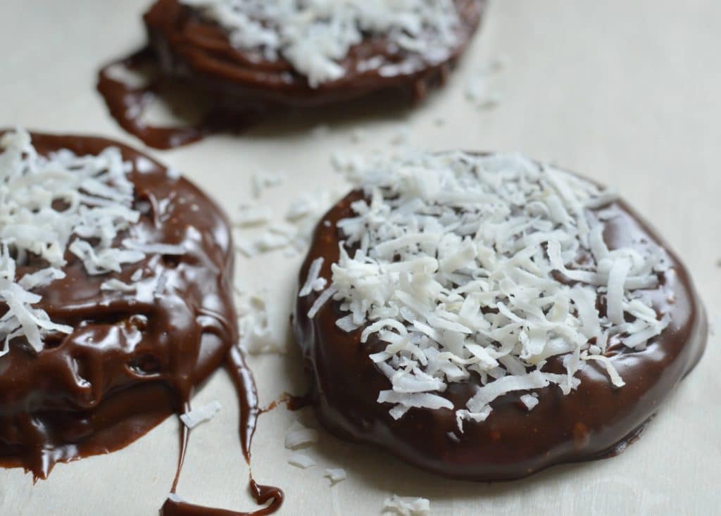 chocolate and coconut covered cookies adding coconut